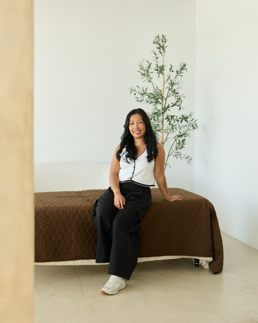 Nicole Coronel seated in a bright, relaxed studio setting.