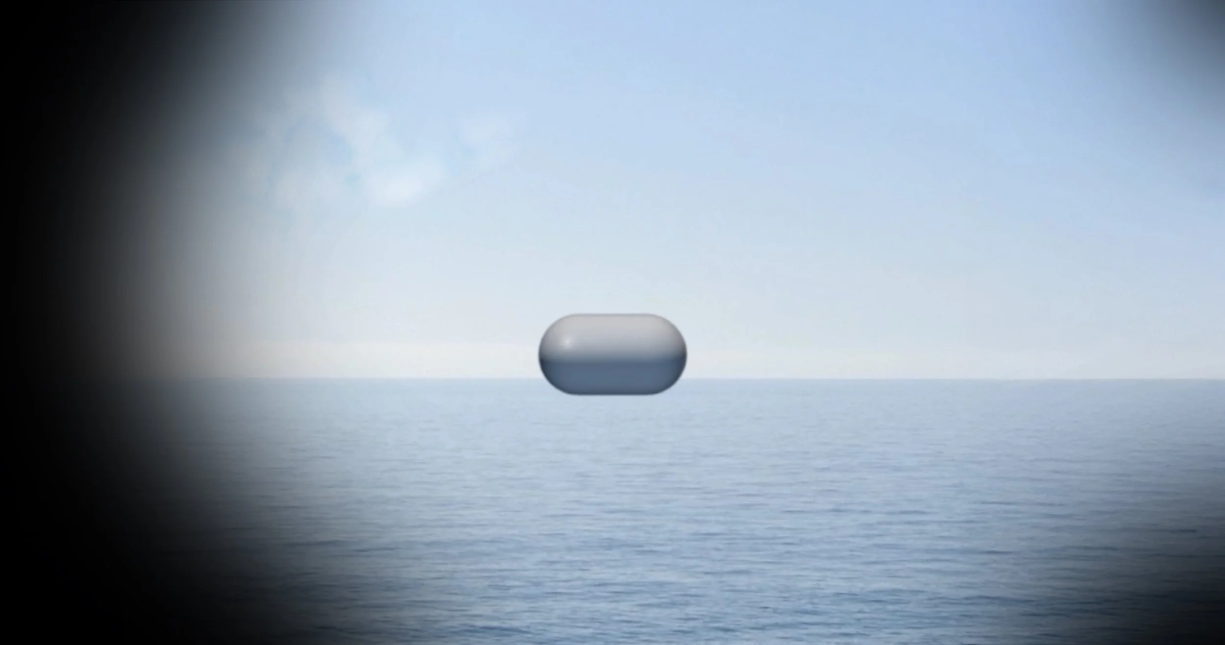 A TicTac-shaped object floating above the ocean with a cloudy sky in the background.