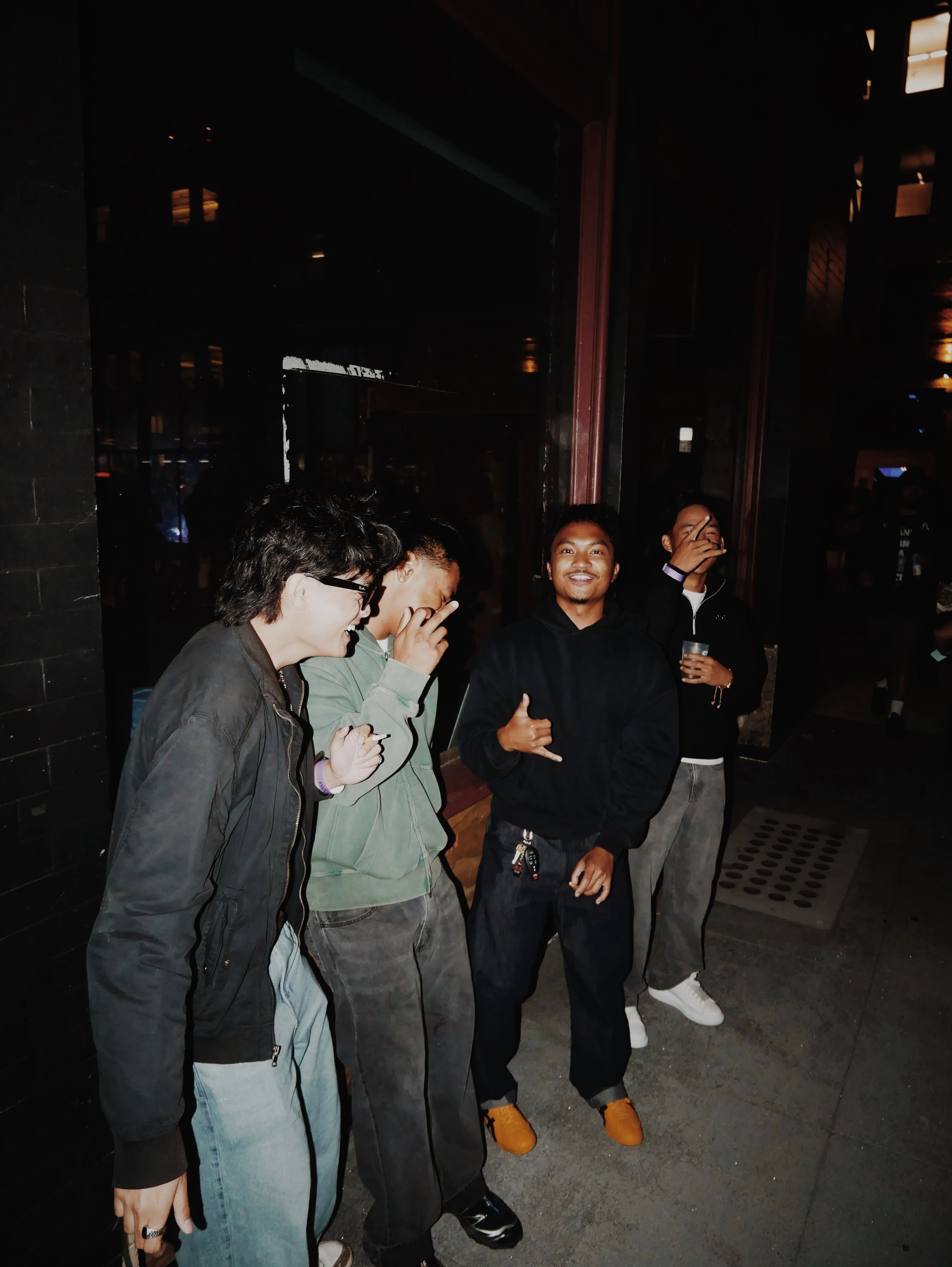 Friends posted up laughing just having a good time 