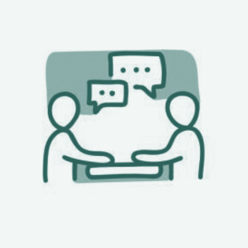 Two people sitting at a table having a conversation with speech bubbles above their heads.