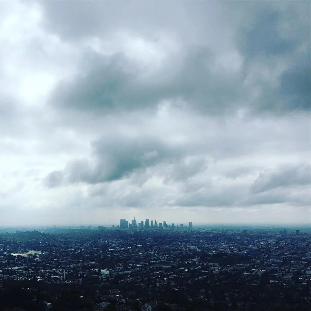 View of Downtown Los Angeles skyline and the clouds above it from the Griffith Observatory in the Hollywood Hills
