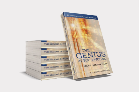 A single book with the cover title "The Genius in Your Wound" rests against a stack of five such books.