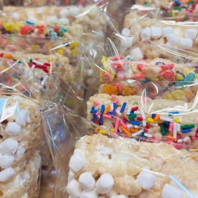 Bagged rice krispie treats decorated with colorful sprinkles and mini marshmallows