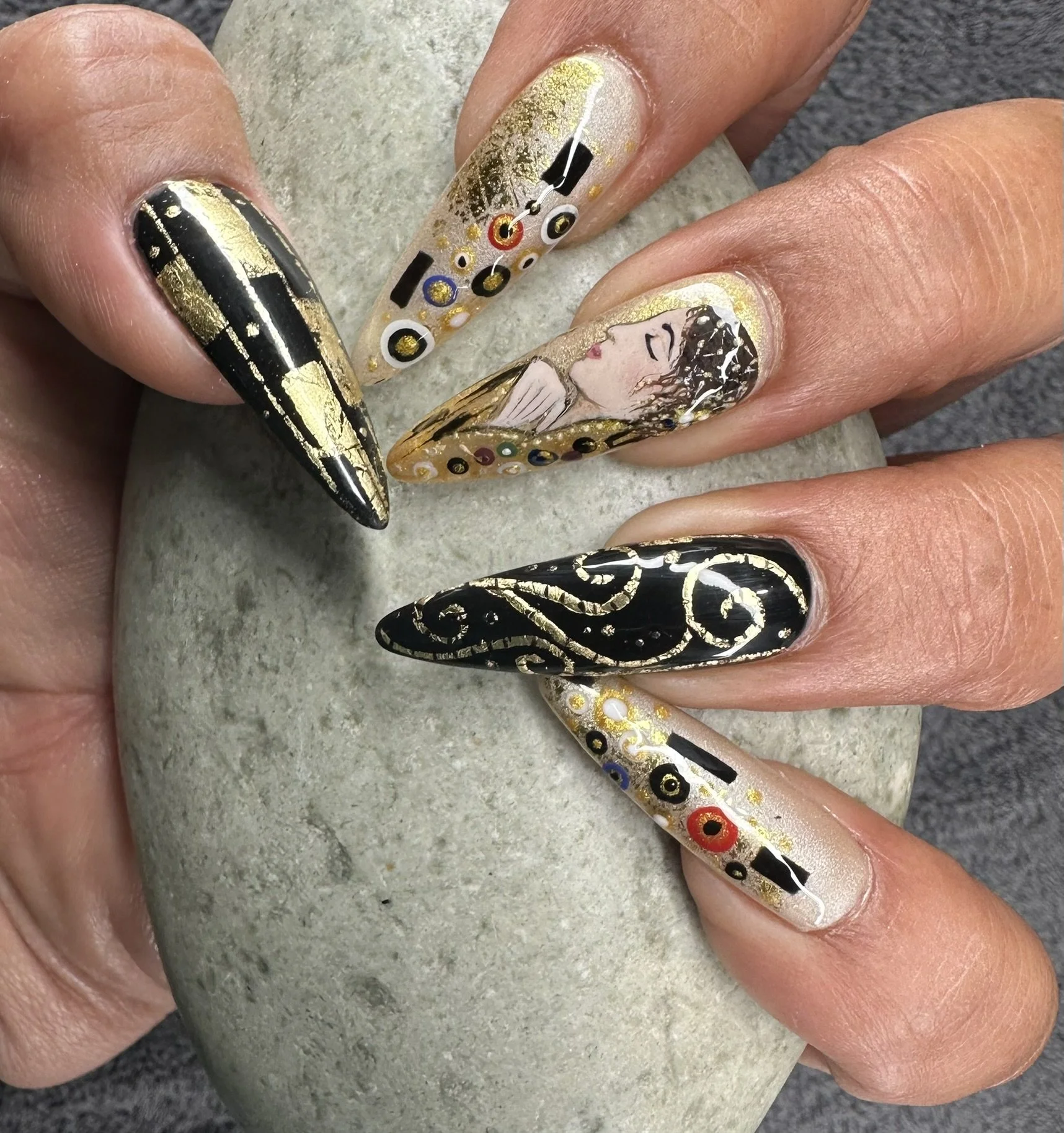 “Detailed black and gold bespoke nail art featuring hand-painted illustration and geometric details, created by Roses Kustom Worx in Taupō.”