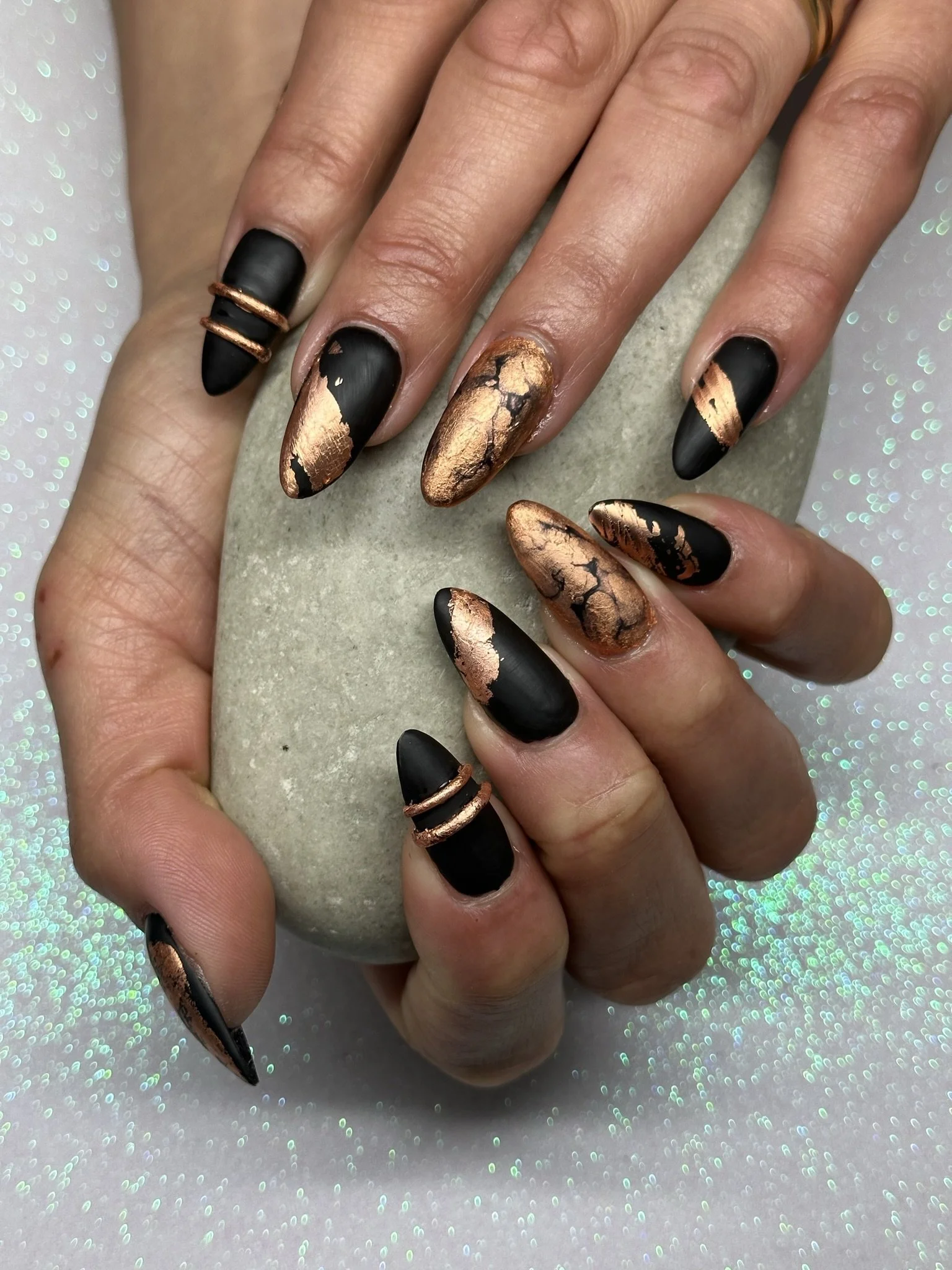 “Black and copper metallic bespoke nail art with detailed accents, created by Roses Kustom Worx in Taupō.”