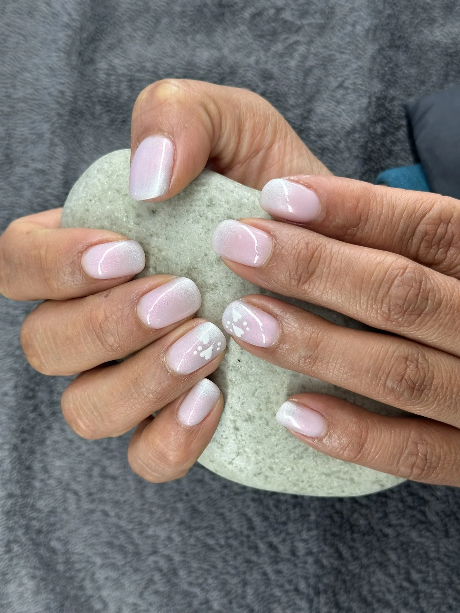 “Soft white French-style manicure with delicate feature nail art, created by Roses Kustom Worx in Taupō.”