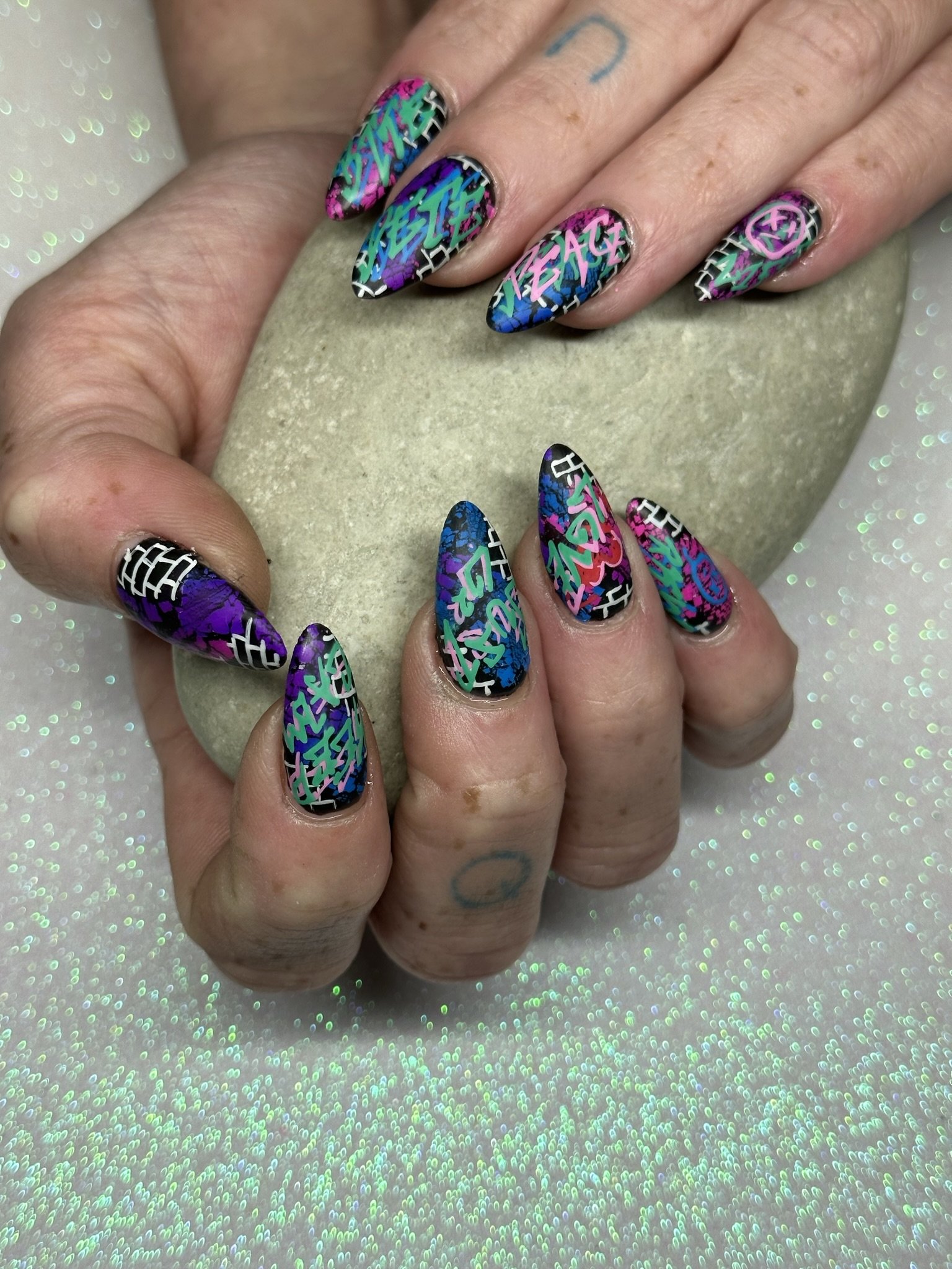 “Colourful holographic nail art with bold abstract details, created by Roses Kustom Worx in Taupō.”