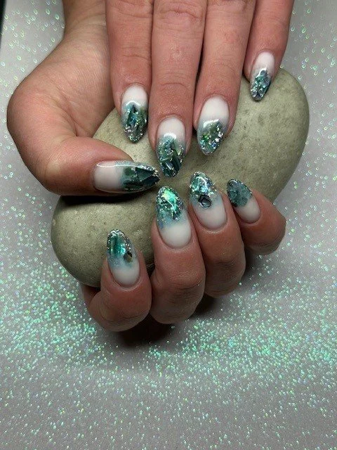 “White and teal glitter nail art with textured details, created by Roses Kustom Worx in Taupō.”