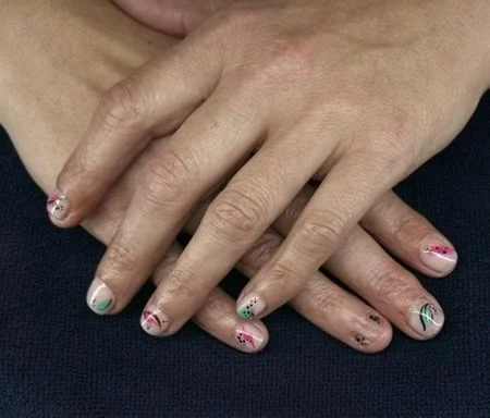 “Colourful nail art featuring pink, green and black details on natural nails, created by Roses Kustom Worx in Taupō.”
