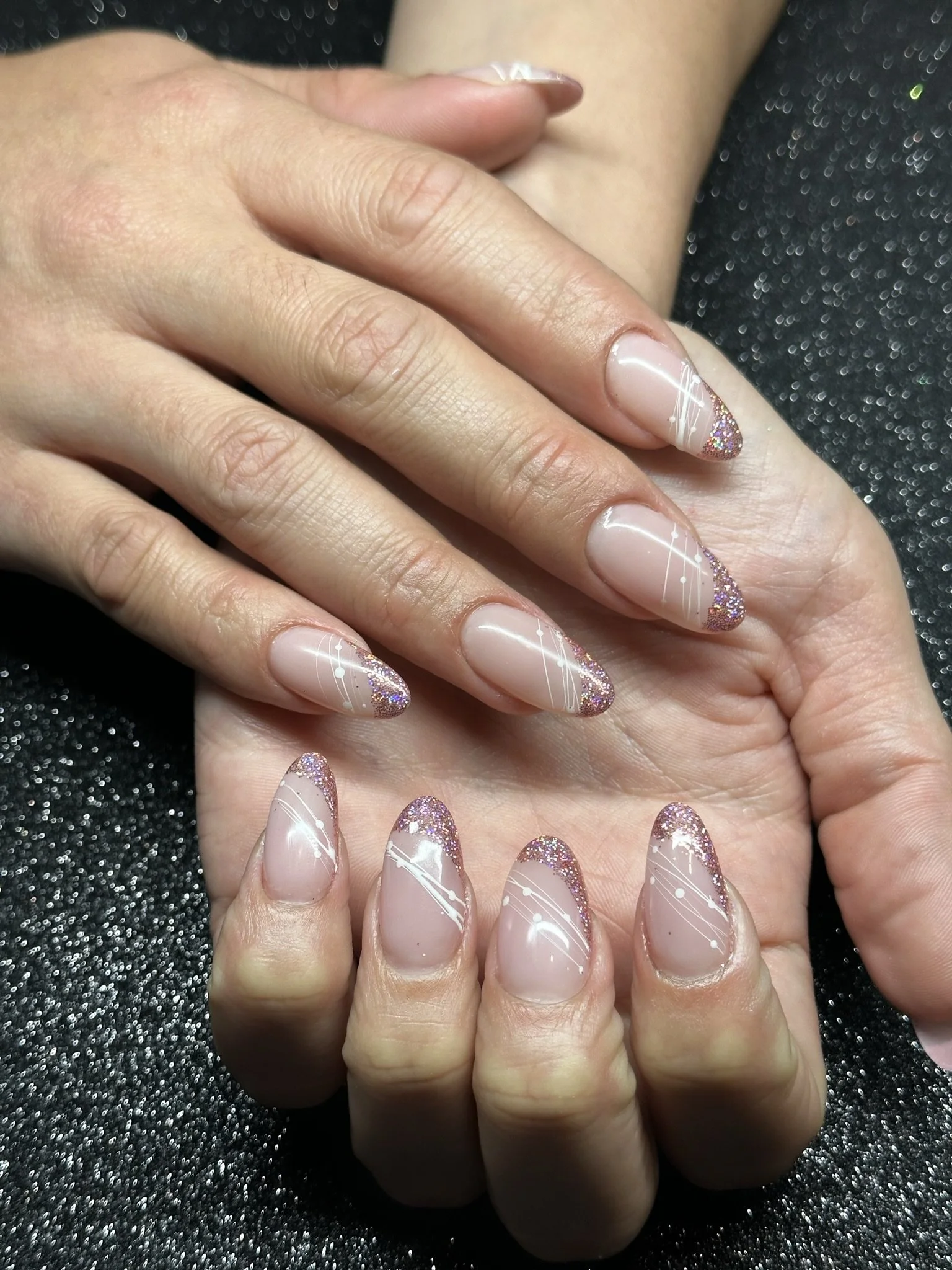 “Soft pink nail art with glitter, white lines and sparkling details, created by Roses Kustom Worx in Taupō.”