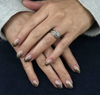 “Soft neutral manicure with delicate gold and silver nail art, created by Roses Kustom Worx in Taupō.”
