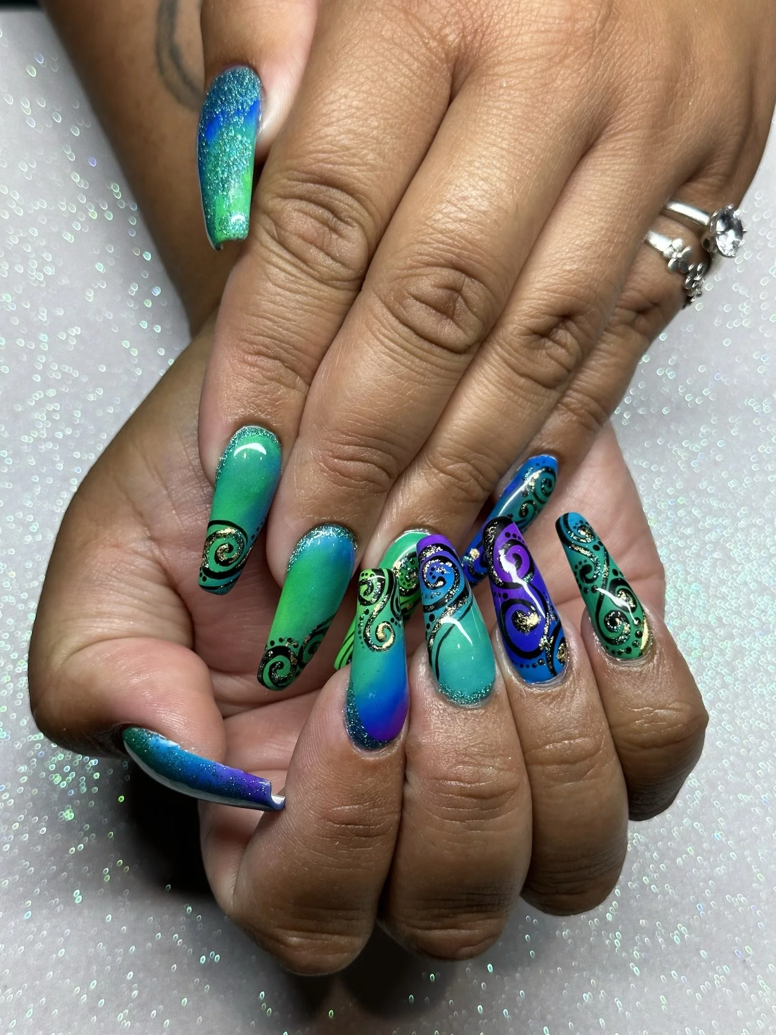 “Vibrant green and blue bespoke nail art on long nails, created by Roses Kustom Worx in Taupō.”
