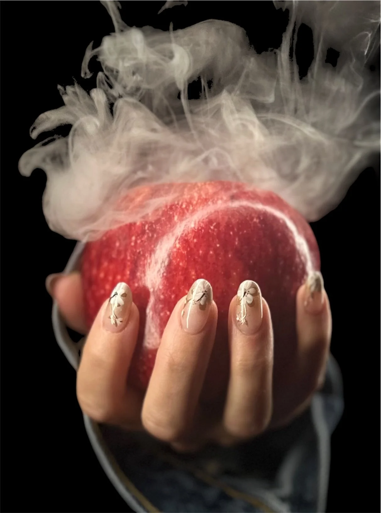 “Creative nail art photoshoot featuring manicured nails holding a red apple, created by Roses Kustom Worx in Taupō.”