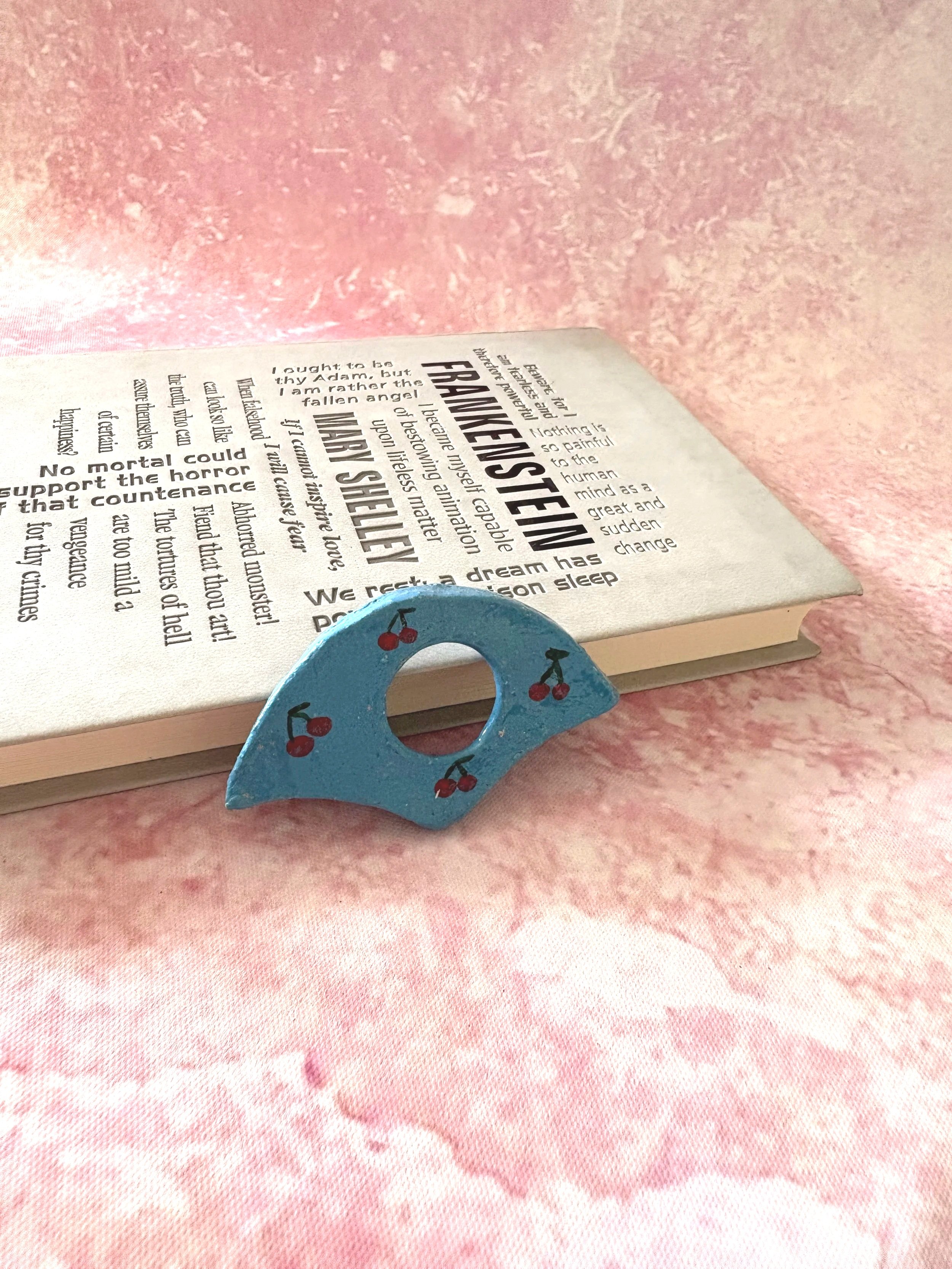 Juicy Cherries pattern, against a blue page holder.