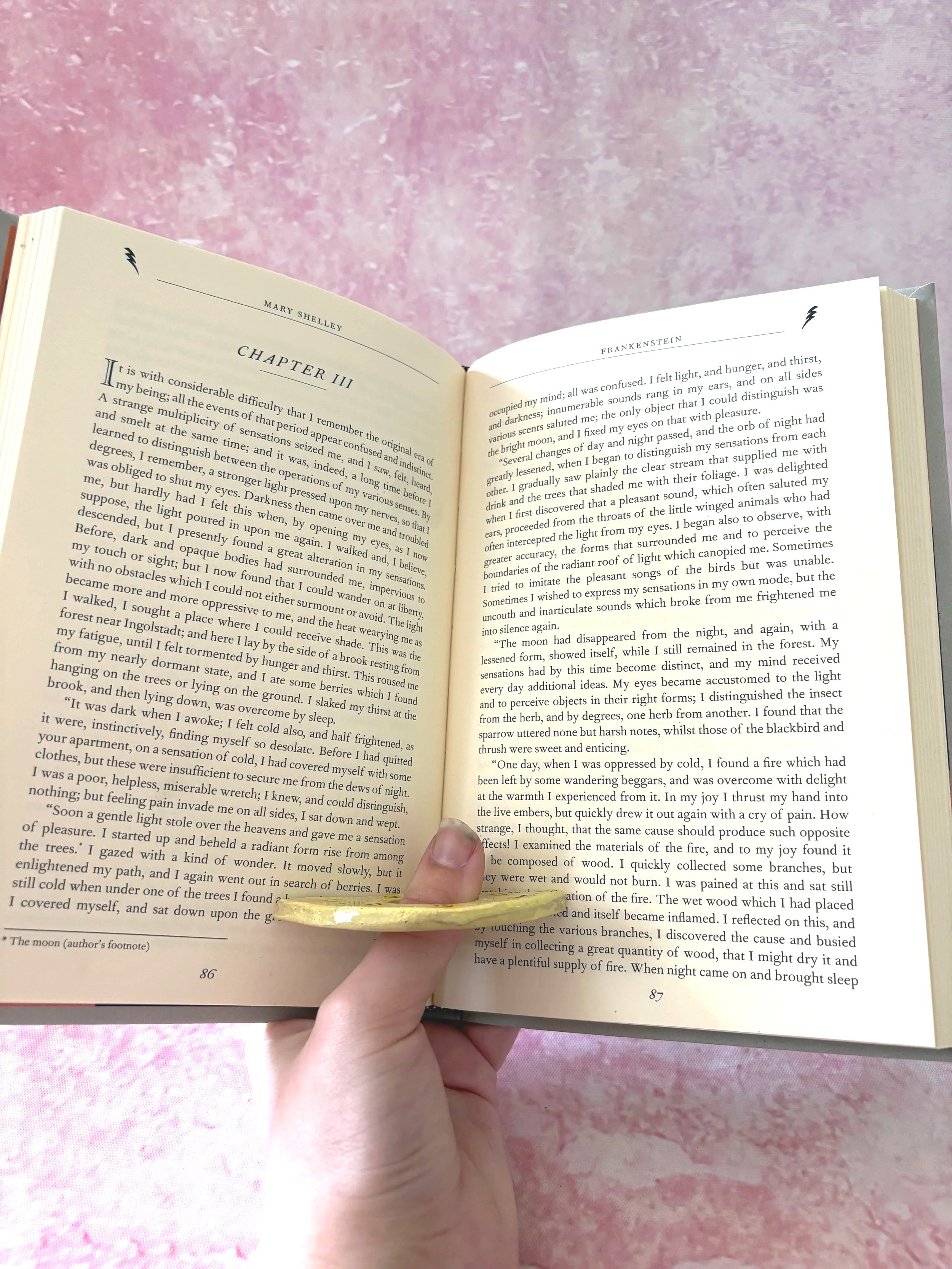 Happy smiles patterned page holder in use, holding a book open.