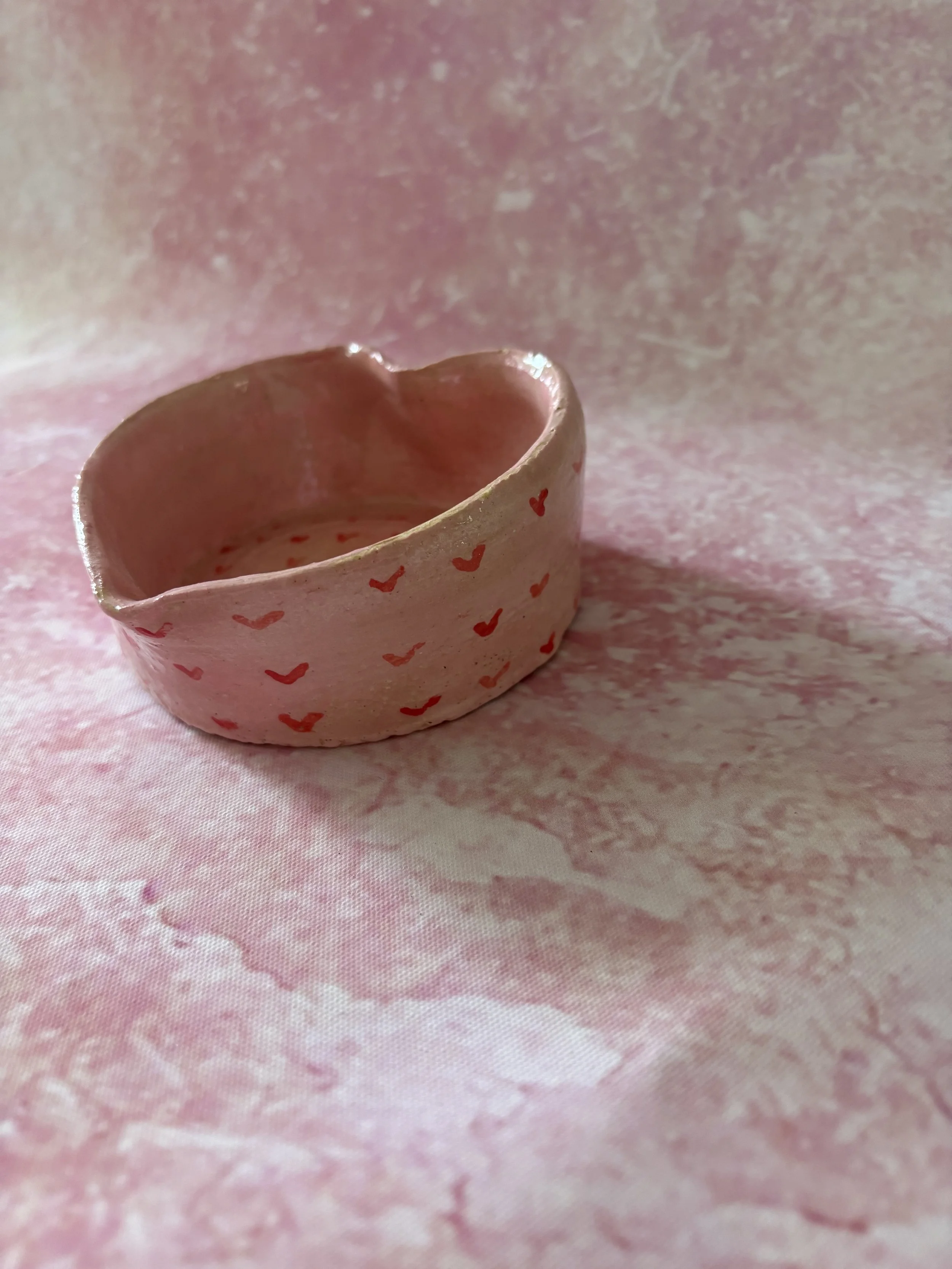 Heart shaped bowl, decorated in pink with red hearts.