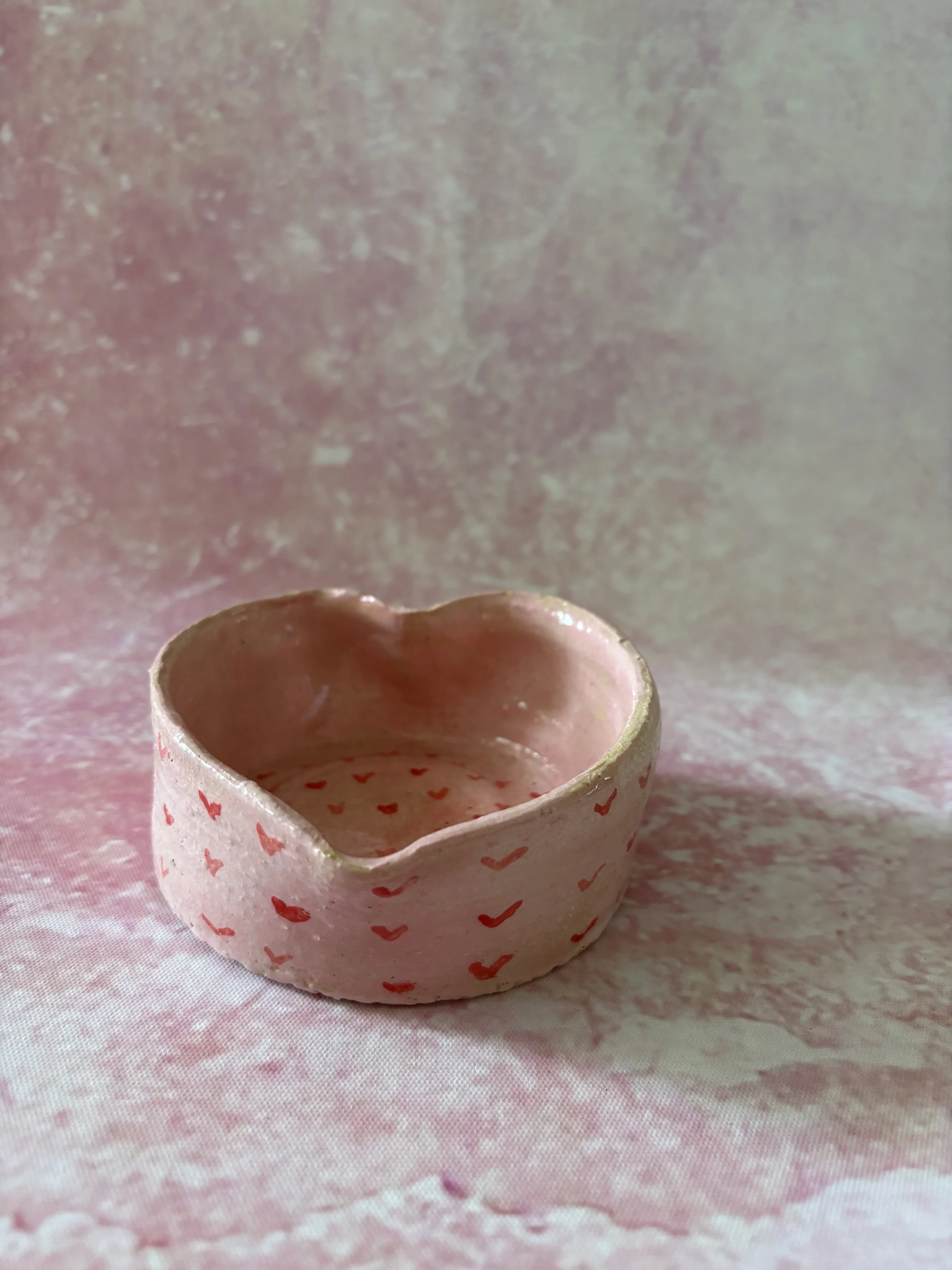 Heart shaped bowl, decorated in pink with red hearts.