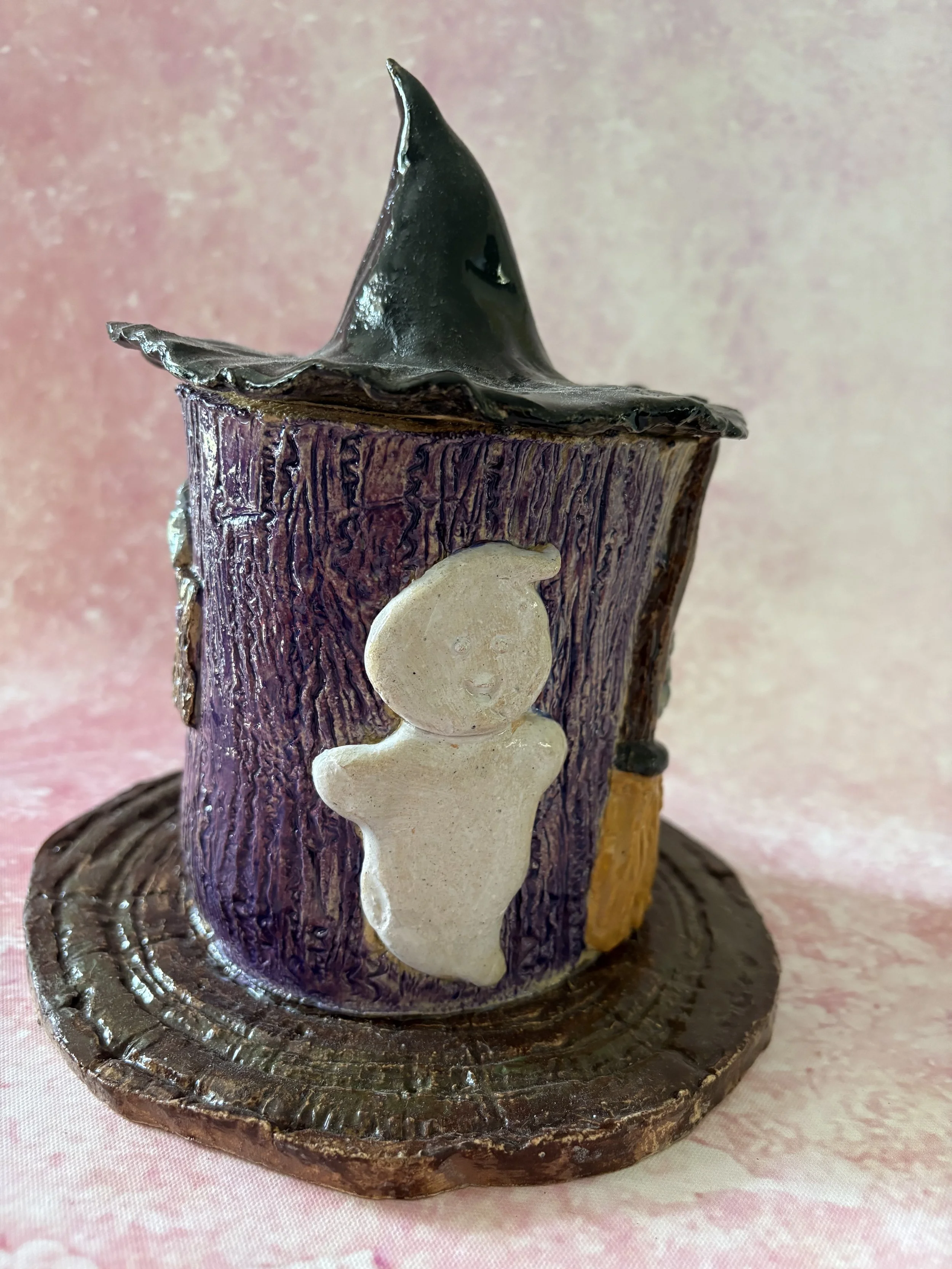 Purple witches cottage, with a ghost to the left of the broomstick.