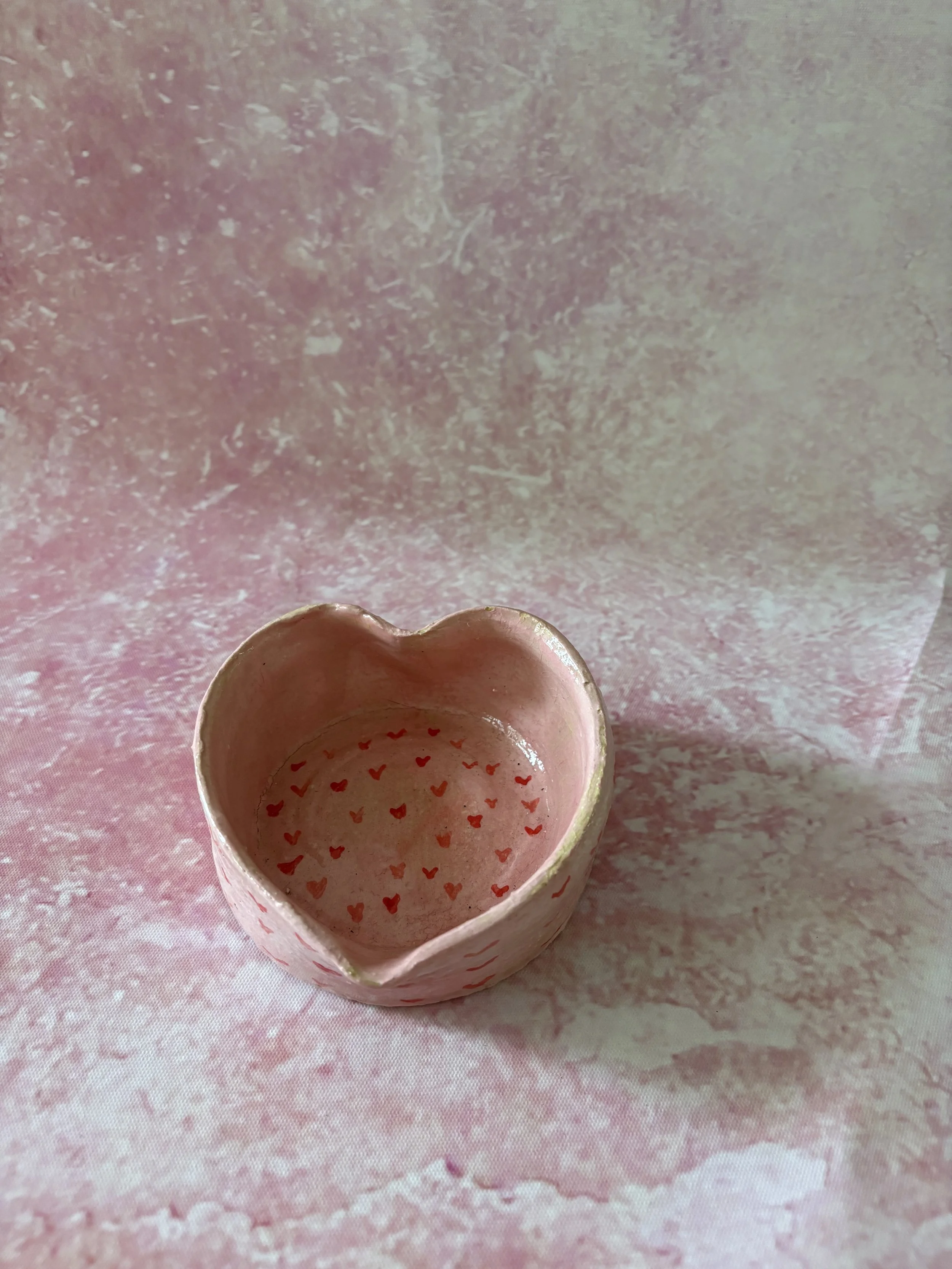 Heart shaped bowl, decorated in pink with red hearts.