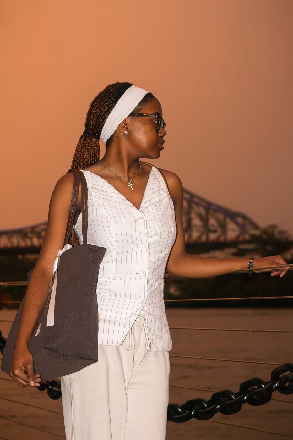 Zee at sunset holding rail bag over shoulder_.jpg