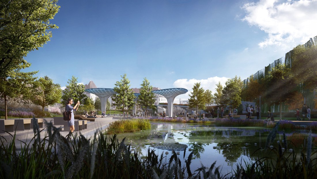 A modern urban park with a pond in the foreground, surrounded by trees and benches. People are walking and relaxing, with some taking photos. In the background, there is a futuristic structure with two large, curving supports and a canopy, along with