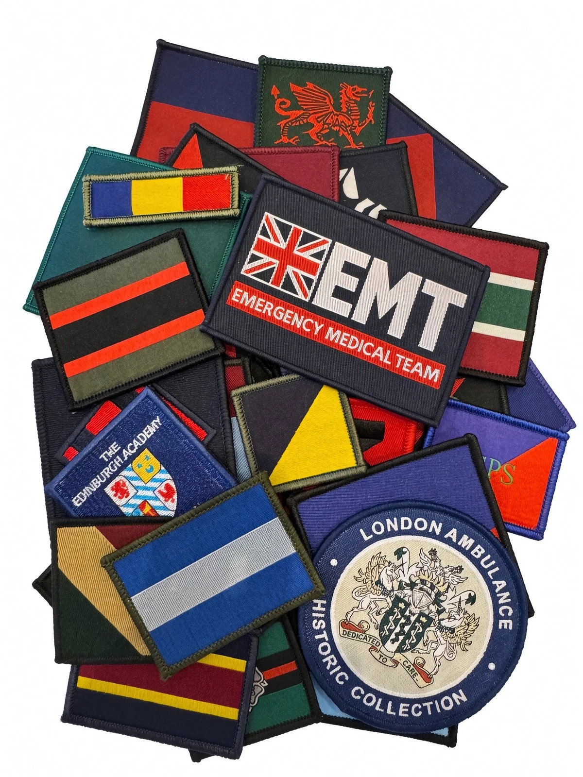 Collection of embroidered patches from various organizations and countries, including emergency medical services, Edinburgh, London Ambulance, and flags of different nations.