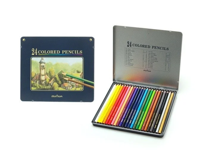 Open metal box containing 24 colored pencils arranged by color, with a lid showing a price list or product details, and a closed box with a landscape illustration on the cover that also states 24 colored pencils.