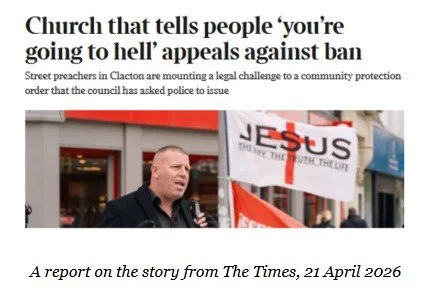 A man speaking at a protest with a sign that says 'JESUS' and a headline about a church opposing a ban, dated April 21, 2026.