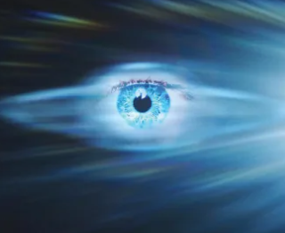 Close-up of a blue human eye with digital effects and streaks of light.