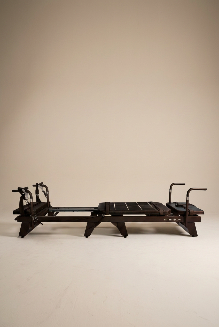 A black Tensionformer machine with straps and bars set on a plain, light-colored background.