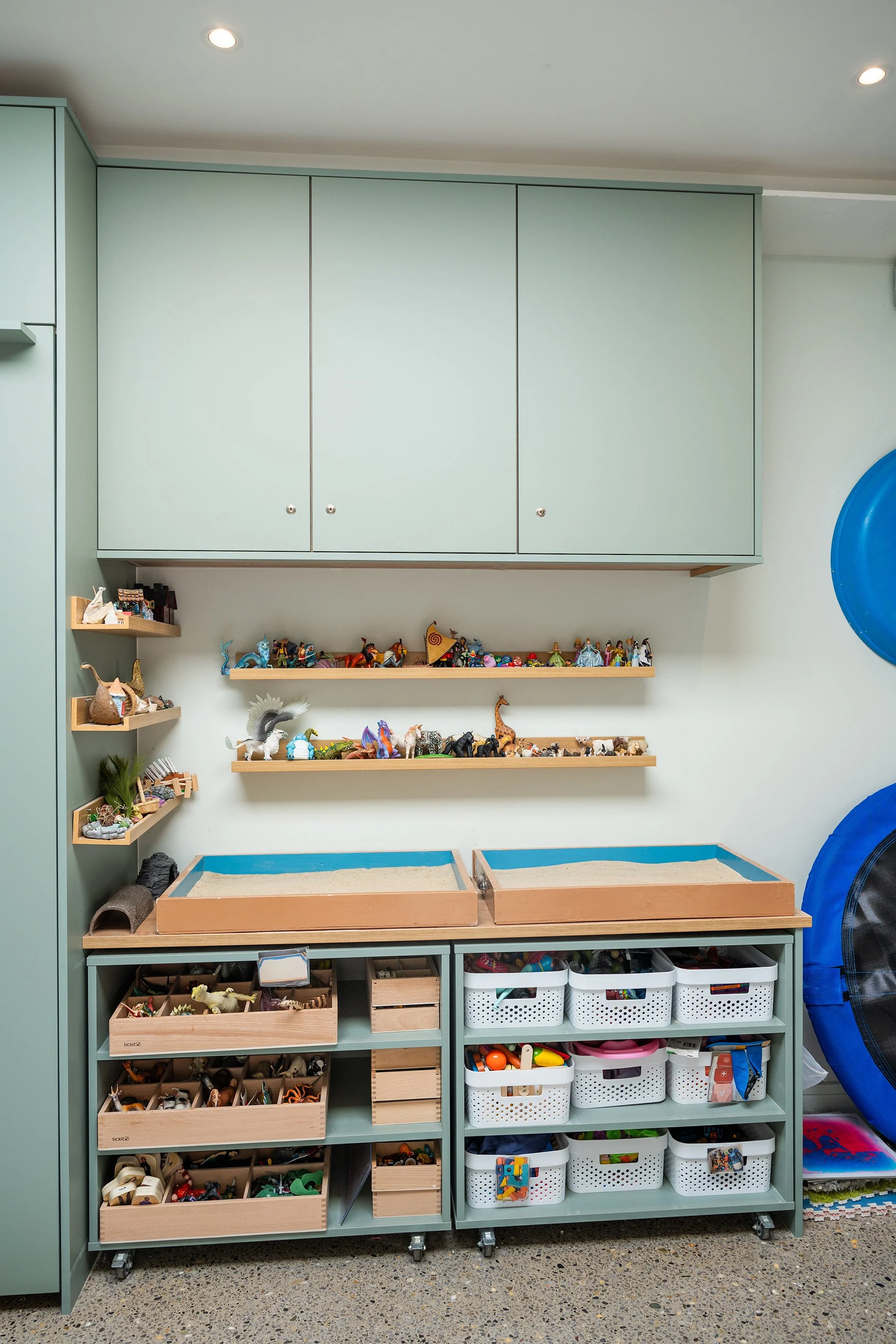 Shelves filled with assorted toys, figurines, and storage boxes.