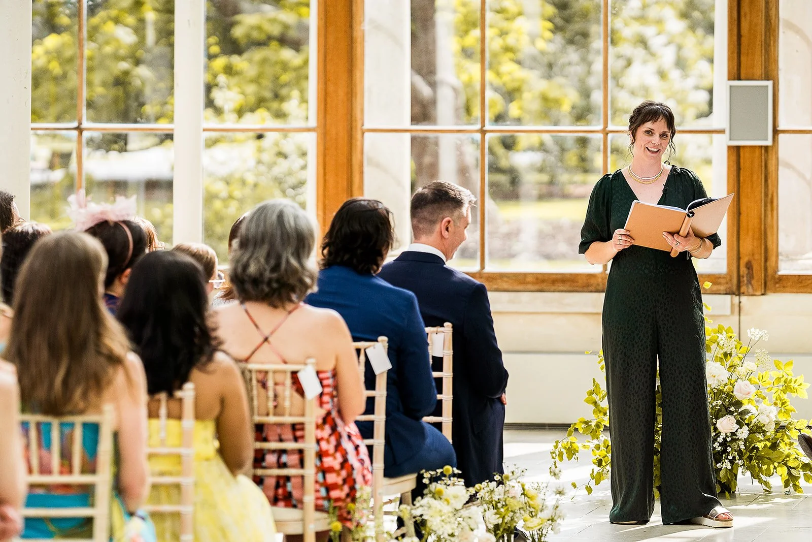 Hannah is smiling and looking out at a sea of guests at a wedding