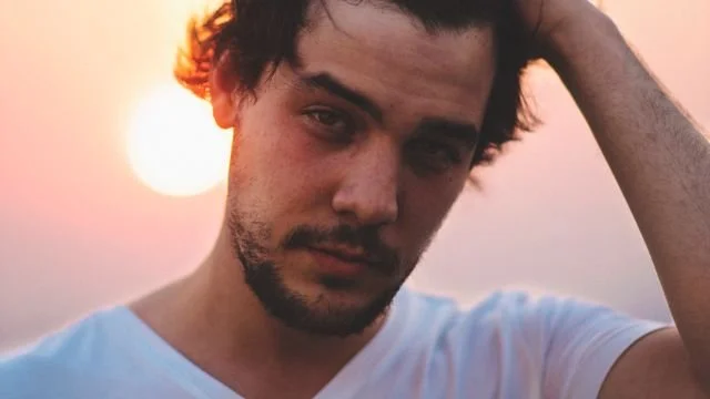 A man with the sun behind him