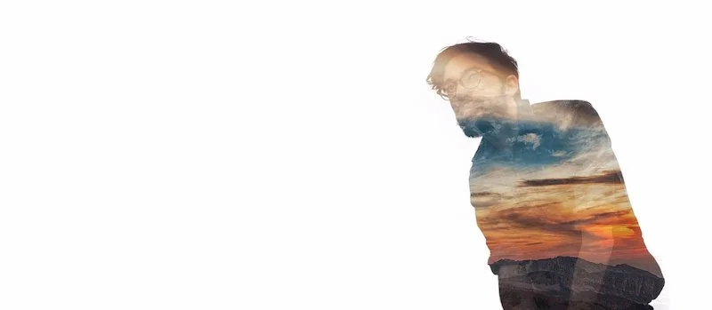 a man overlayed with a sunset scene