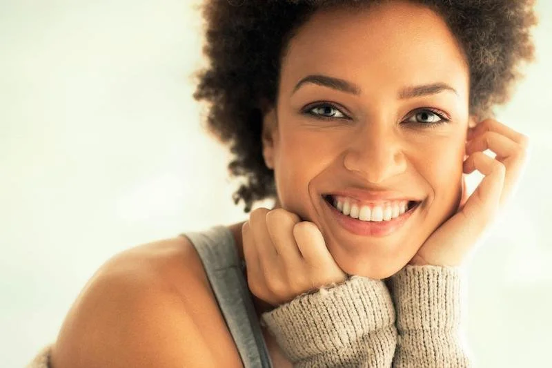 A black woman smiling feeling happy