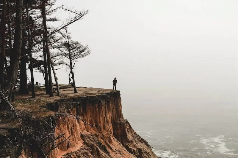 a man on a cliff looking down