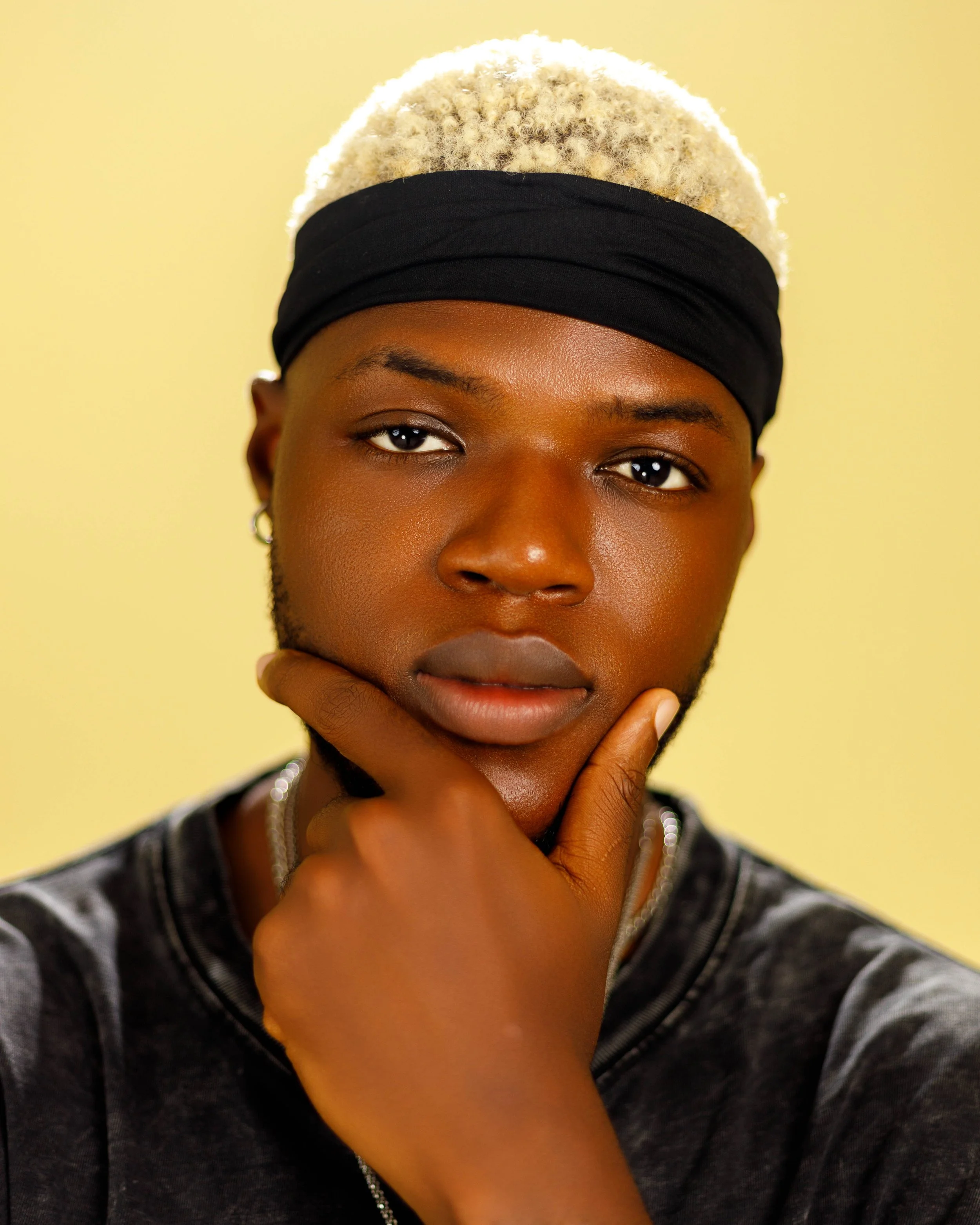 Close-up portrait of Spyrex against a yellow background