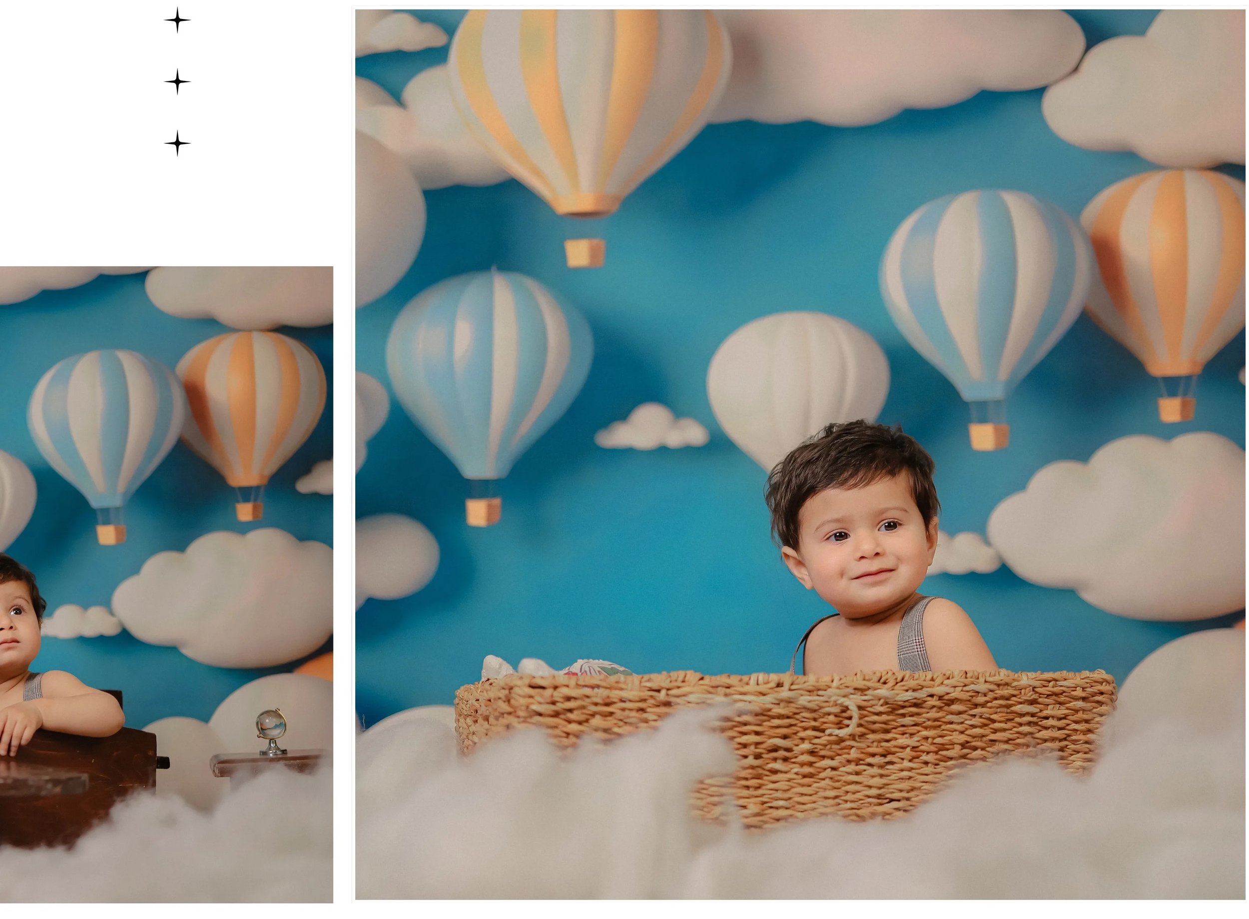 A young boy with dark hair and a striped tank top standing in front of a bright blue sky mural with hot air balloons and clouds, with a woven basket on the table in front of him.