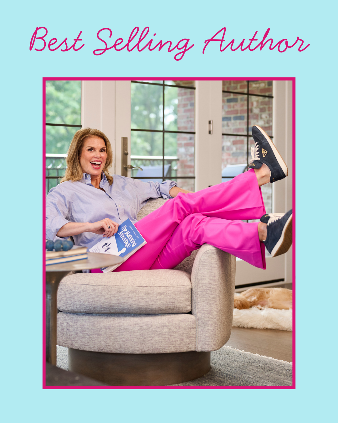 Woman sitting on a couch with legs up, holding a book titled 'The Matching Advantage,' smiling, with a dog lying on a rug in the background.