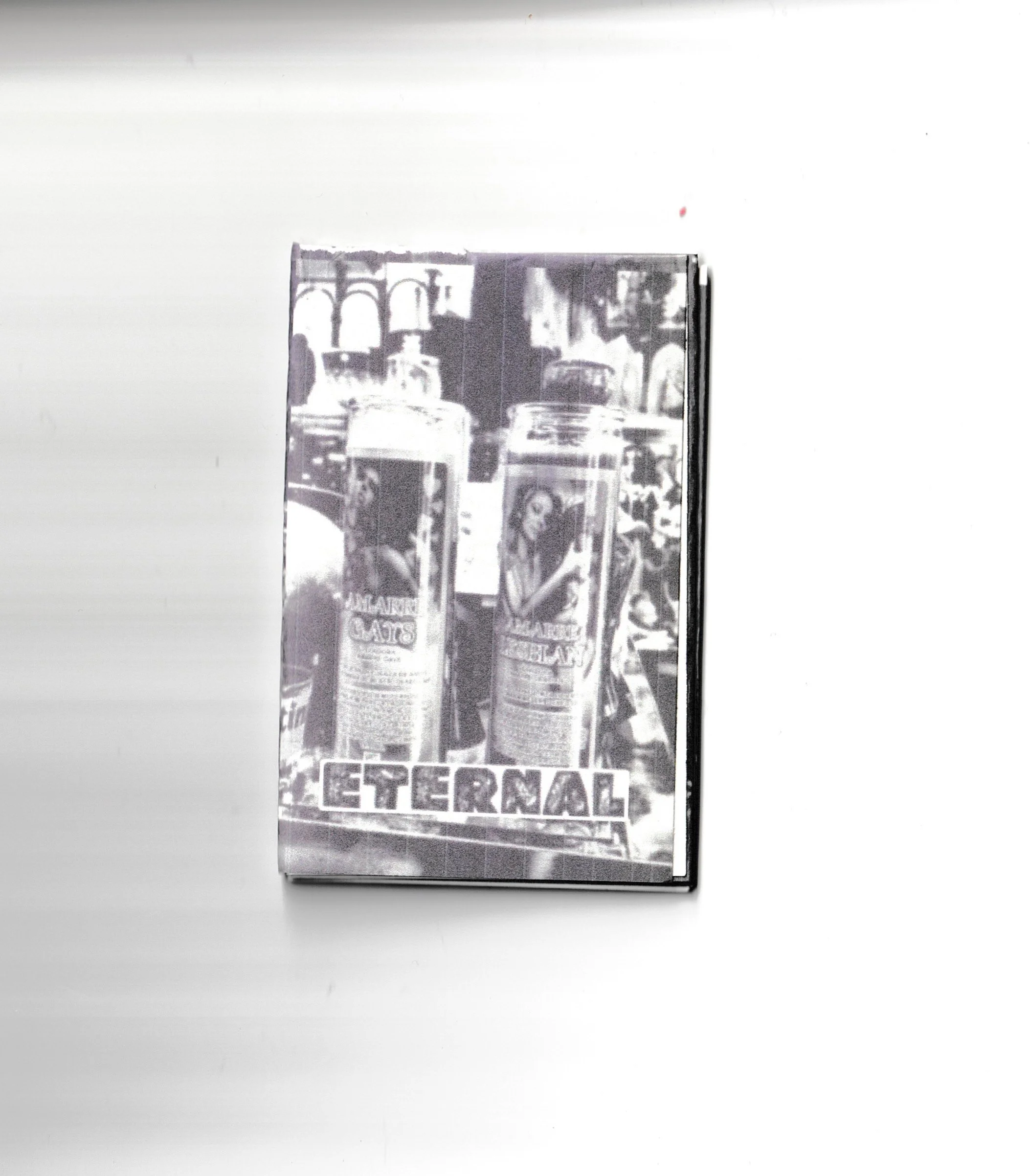 Black and white photograph of various cans, bottles, and food packaging arranged on a shelf, including re-ment branding.