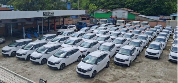 A lot of white cars parked at a car dealership lot.