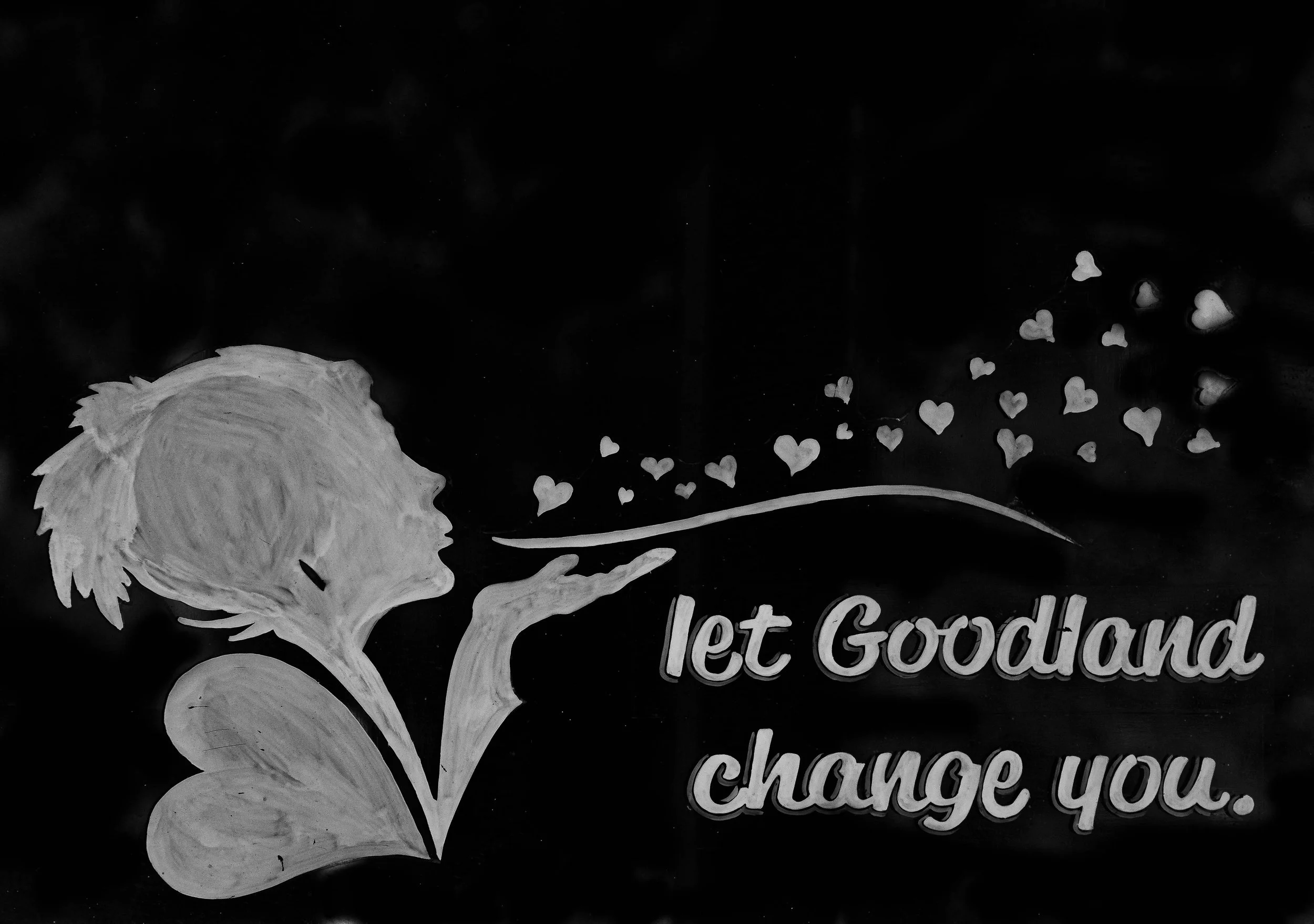 A chalkboard with a white chalk drawing of a young person's profile with hair and a flower, surrounded by small hearts and partially visible text that begins with "lett, Goud..." and ends with "change you."