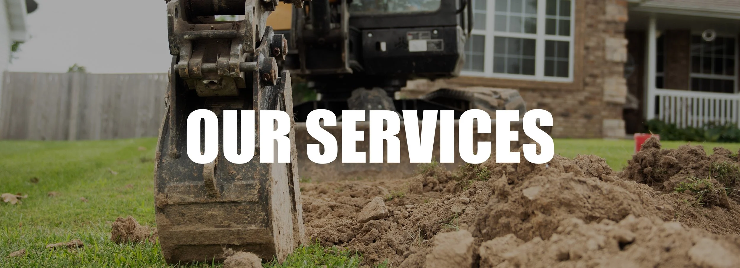 A close-up of construction equipment, specifically the bucket of an excavator, digging into the ground in a backyard with a house and a wooden fence in the background, overlaid with the words 'OUR SERVICES' in bold white text.