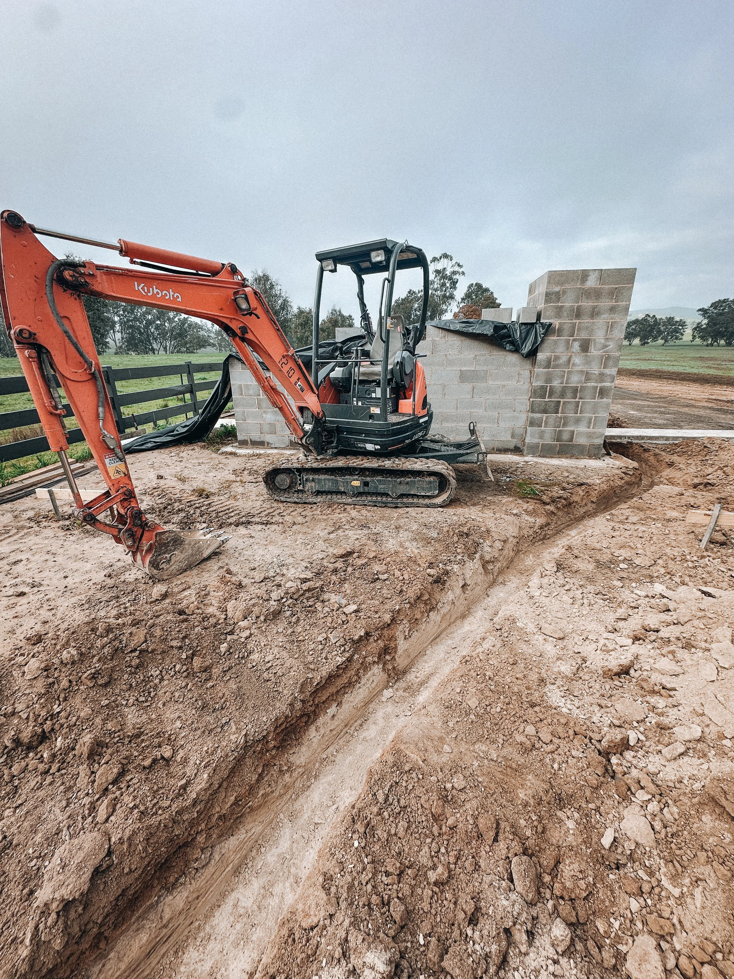 DTE Land Management site excavation with mini excavator digging a trench in rural Central Victoria