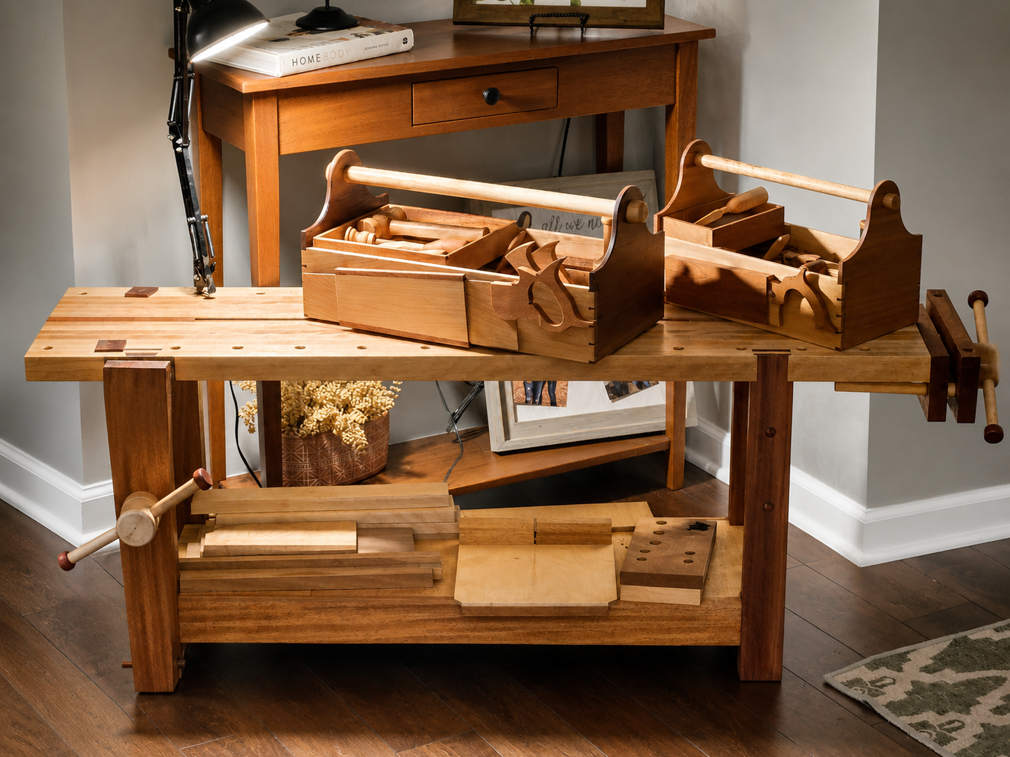 Woodworking workbench with organized wooden drawers and tools, a lamp, and a potted plant in the background.