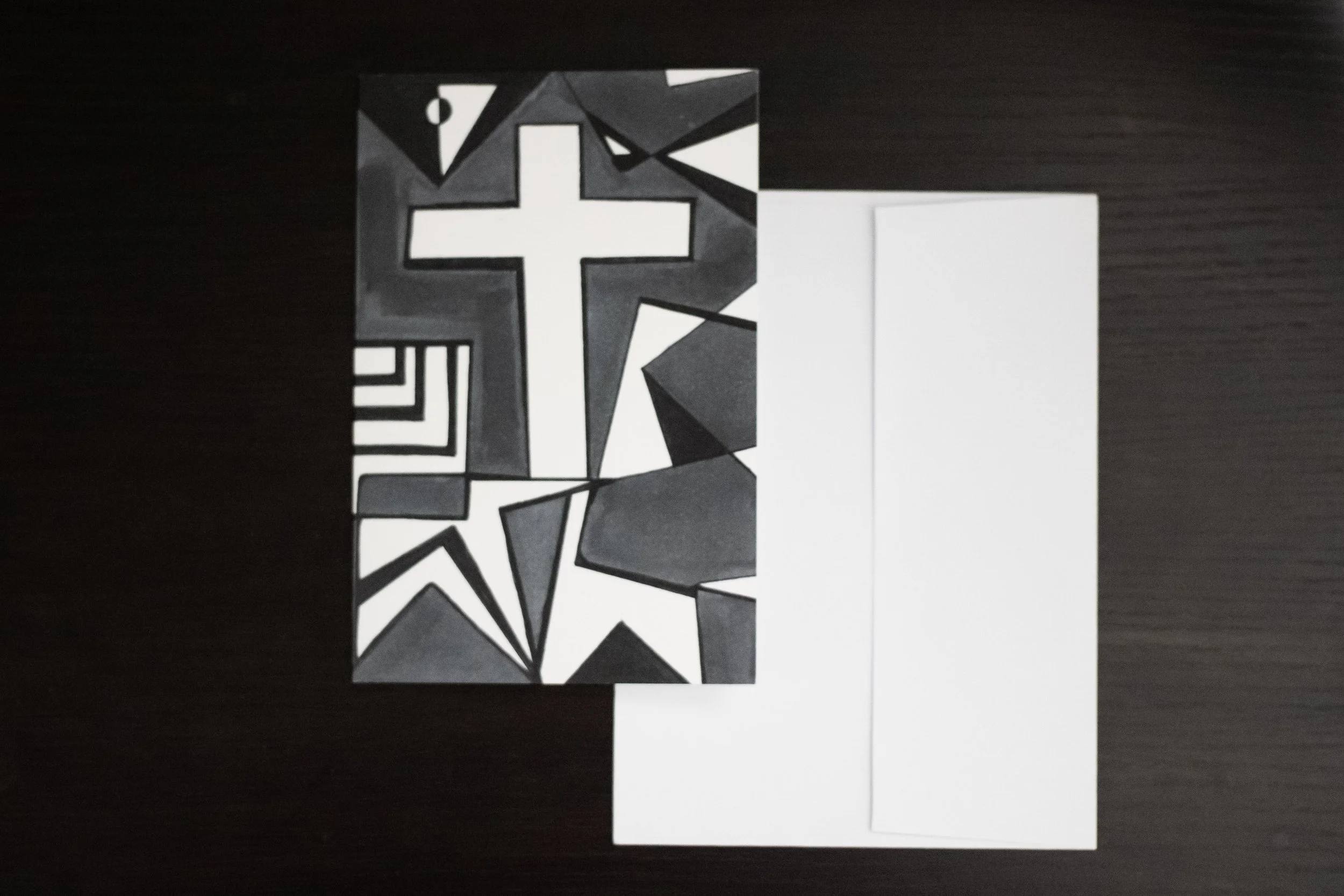 Blank notecard with Cross Art on the front: black, white, and gray abstract geometric artwork with a prominent white cross or plus symbol in the center.