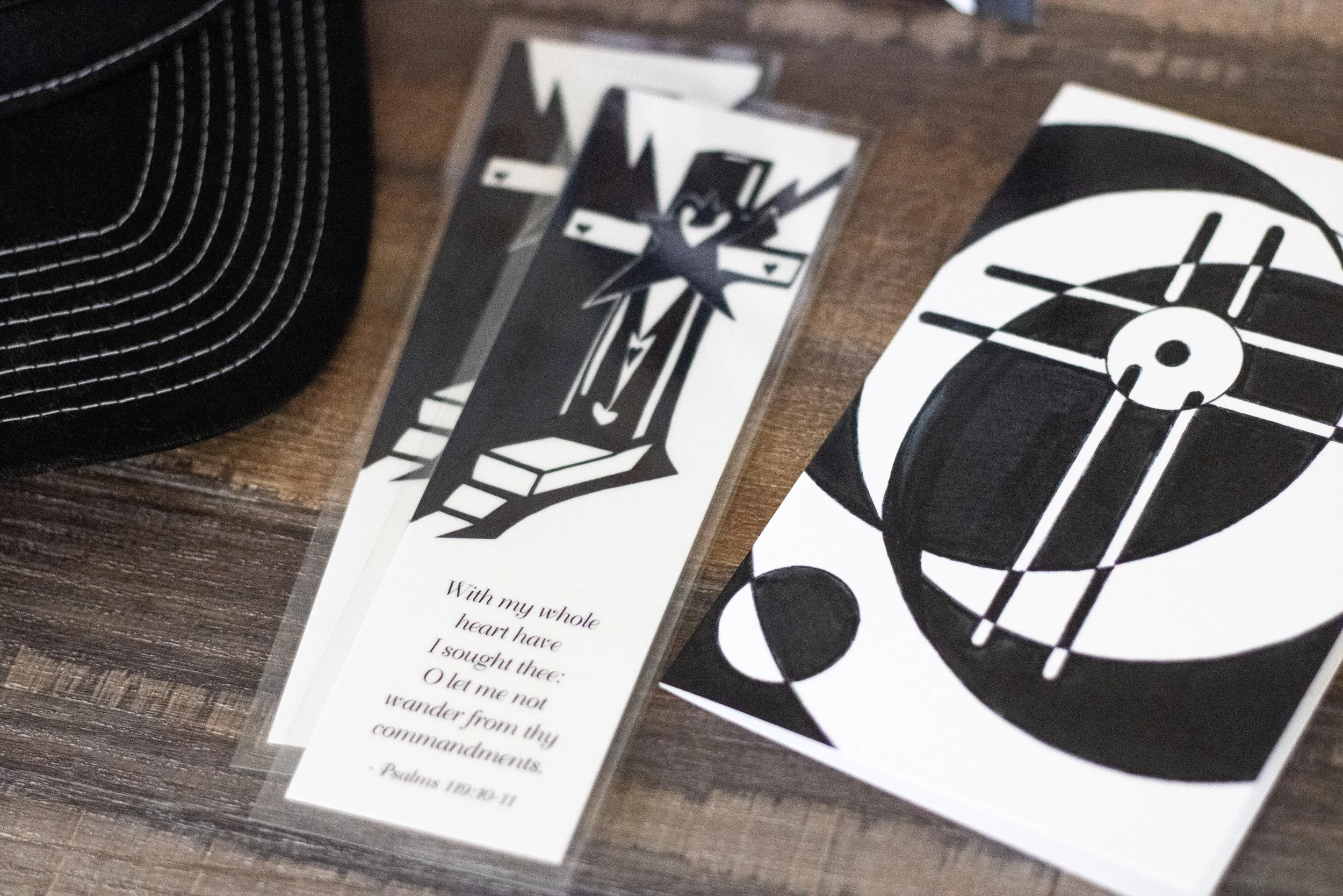 Black and white bookmark design featuring a cross and abstract shapes.