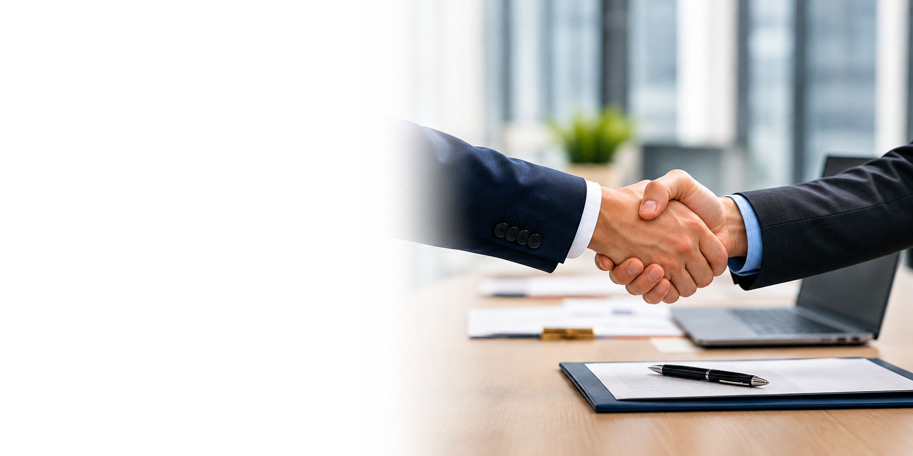 Businessmen handshaking over a signed form.