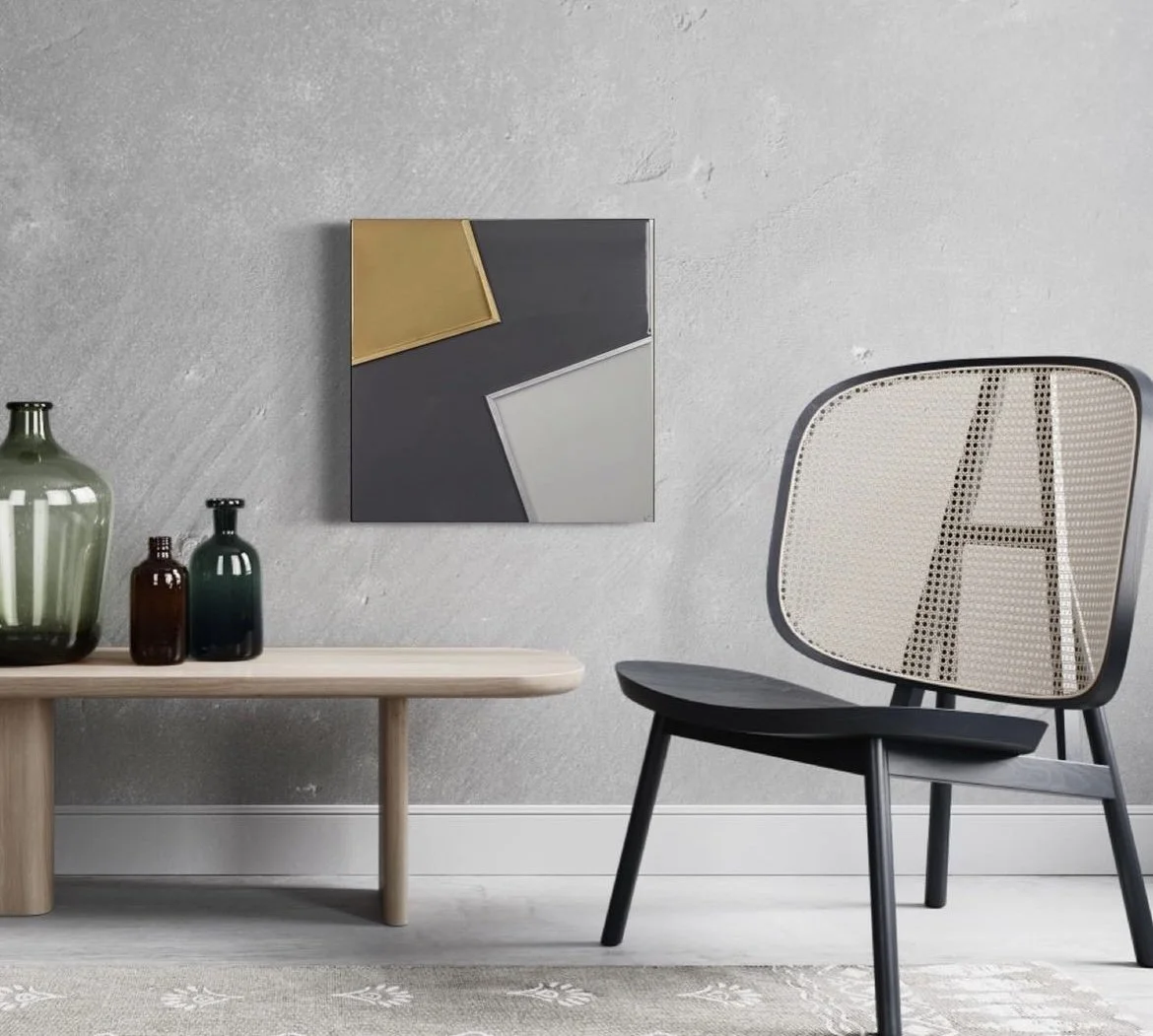 Modern living room with beige and black chair, wooden bench with decorative bottles, small colorful abstract art on light gray textured wall, and a patterned rug.