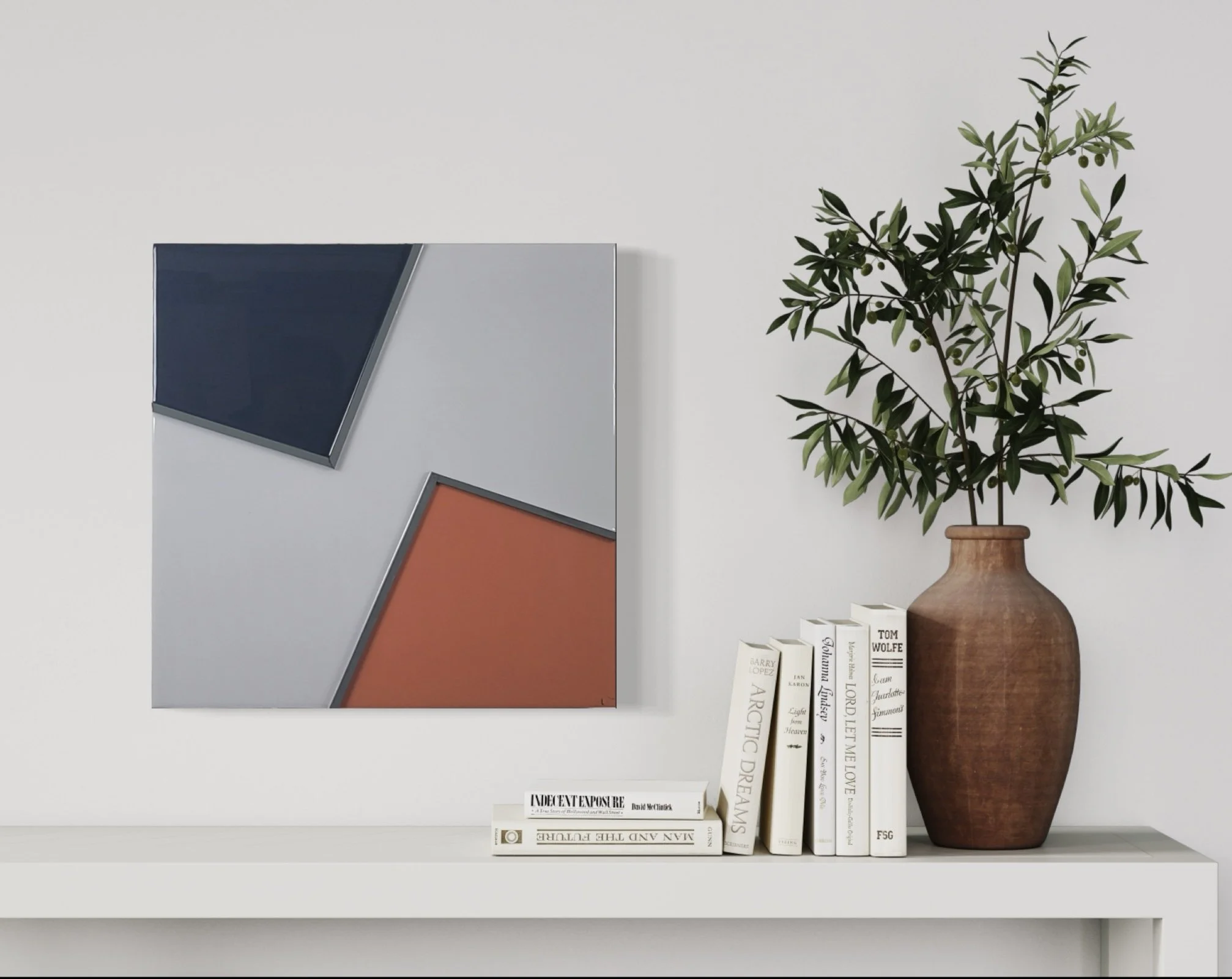 White shelf with a potted olive tree, several books standing upright, and some lying flat with titles visible.